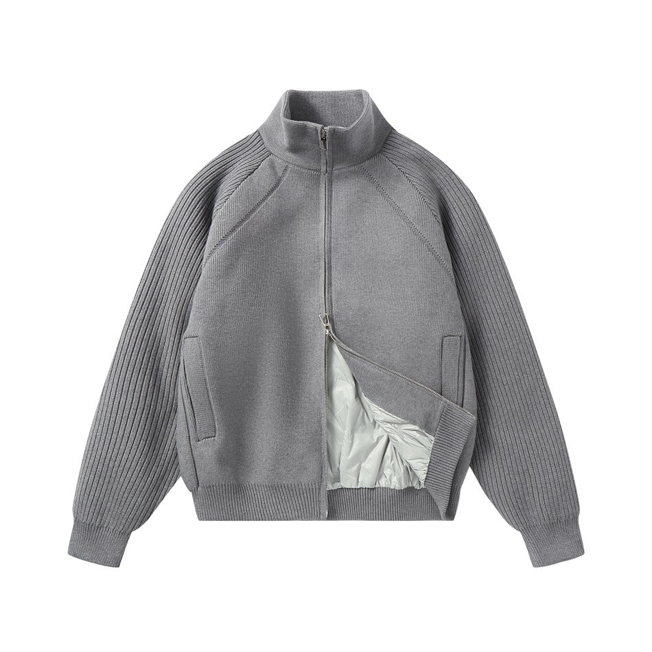 Gray knit stand-collar zip jacket partly unzipped, showing a light quilted inner layer, ribbed sleeves and pockets