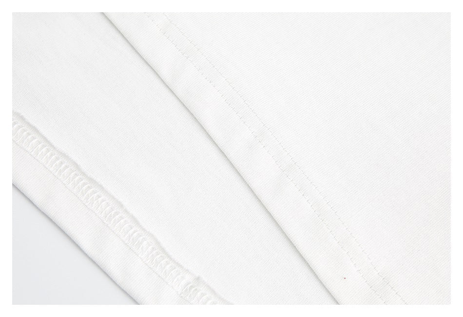 Close-up of white shirt fabric showing a stitched seam and overlocked edge.