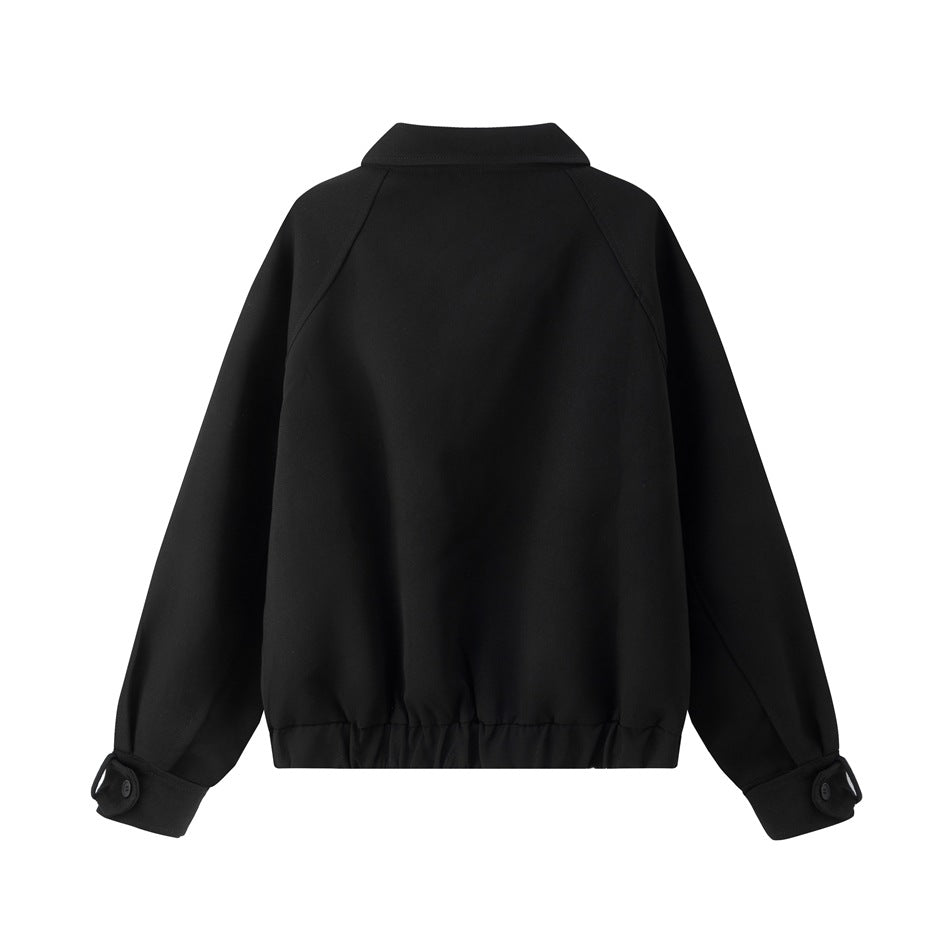 Back view of a black jacket with raglan sleeves, a short collar, buttoned cuffs, and a gathered hem on a white background.