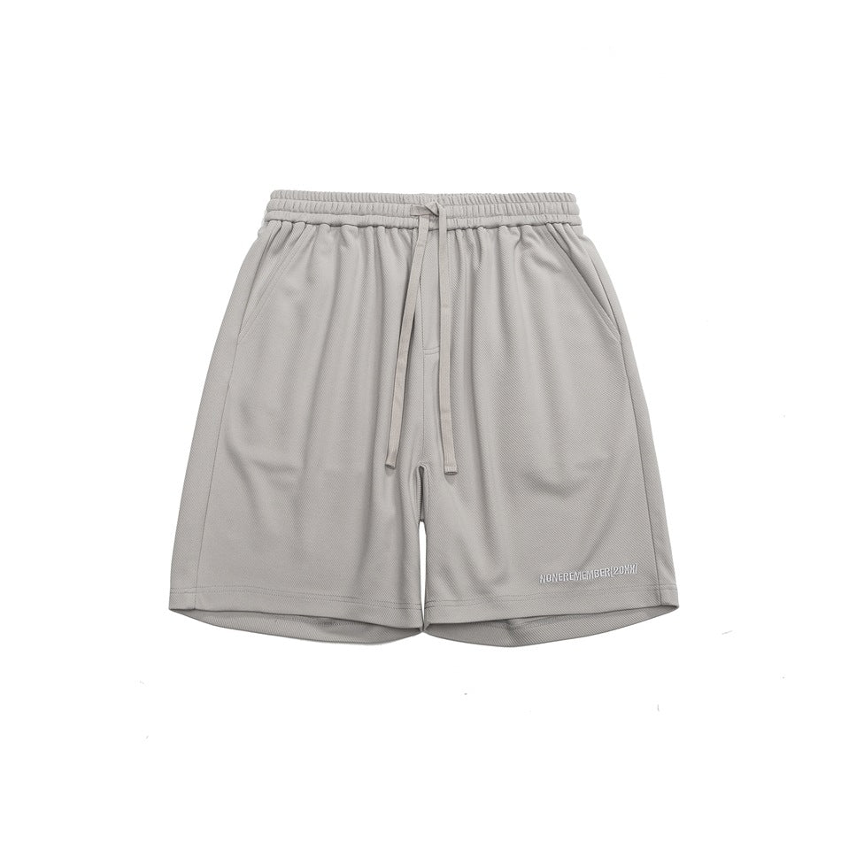Gray drawstring shorts, front flat lay, with small embroidered lettering near the hem of one leg