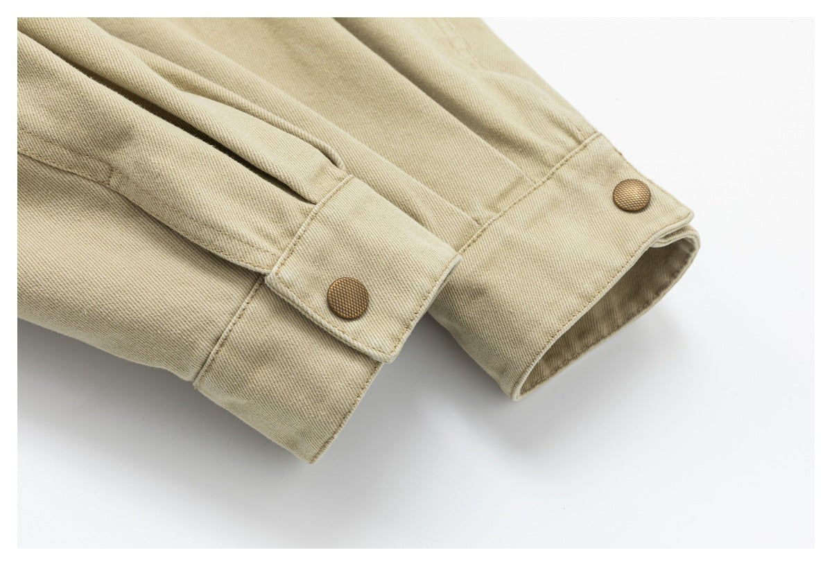 Close-up of the jacket's sleeve cuffs, each with a brown snap button.