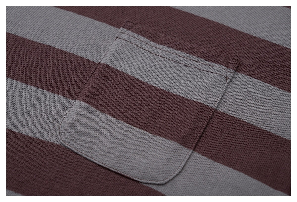Close-up of the rectangular chest pocket on a burgundy and gray striped T-shirt.