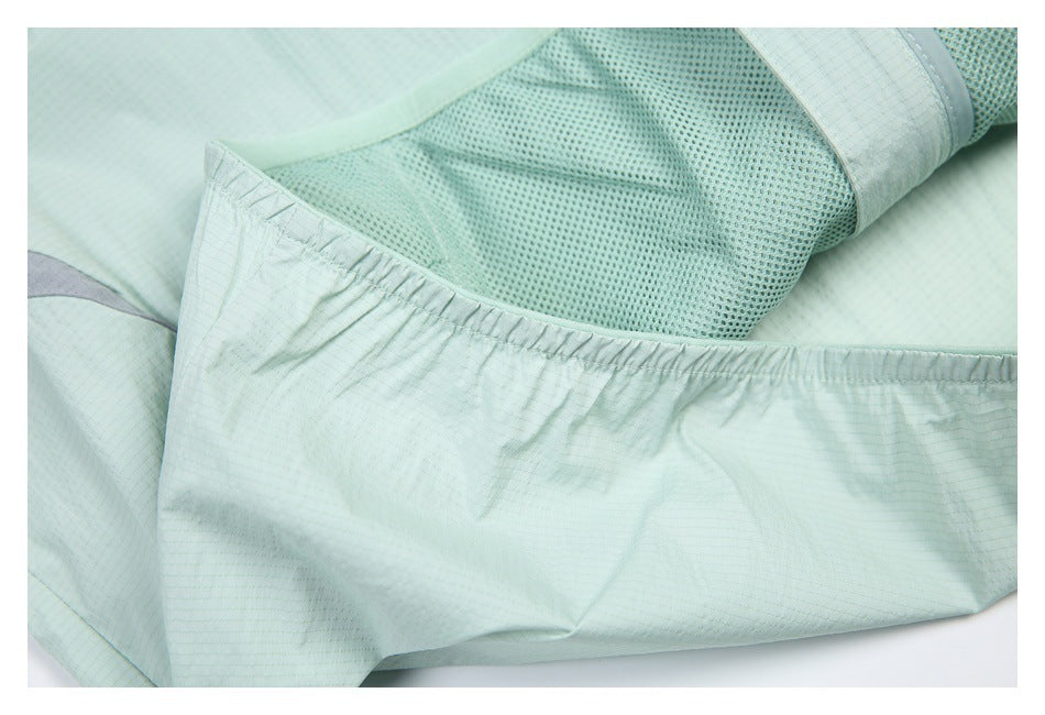 Close-up of the pale mint jacket's interior mesh lining and gathered edge.