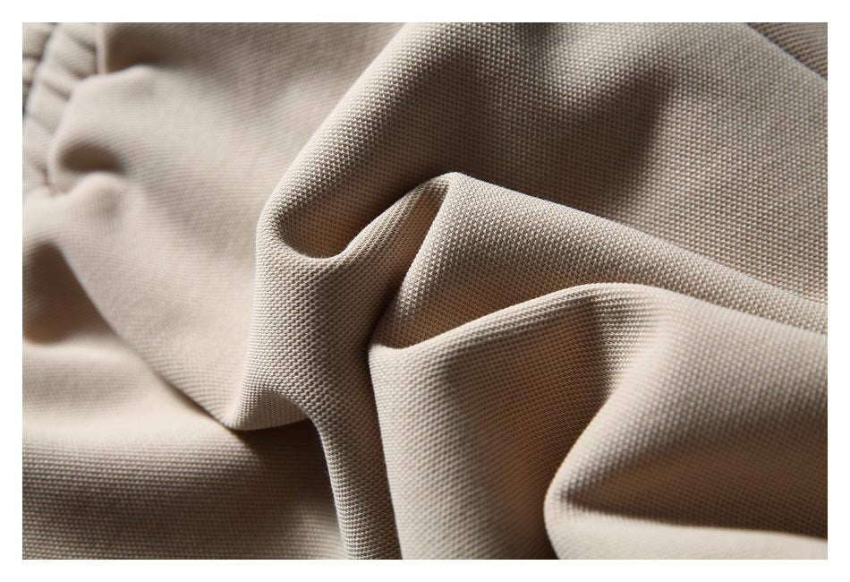 Close-up showing the textured weave and folds of light beige fabric.