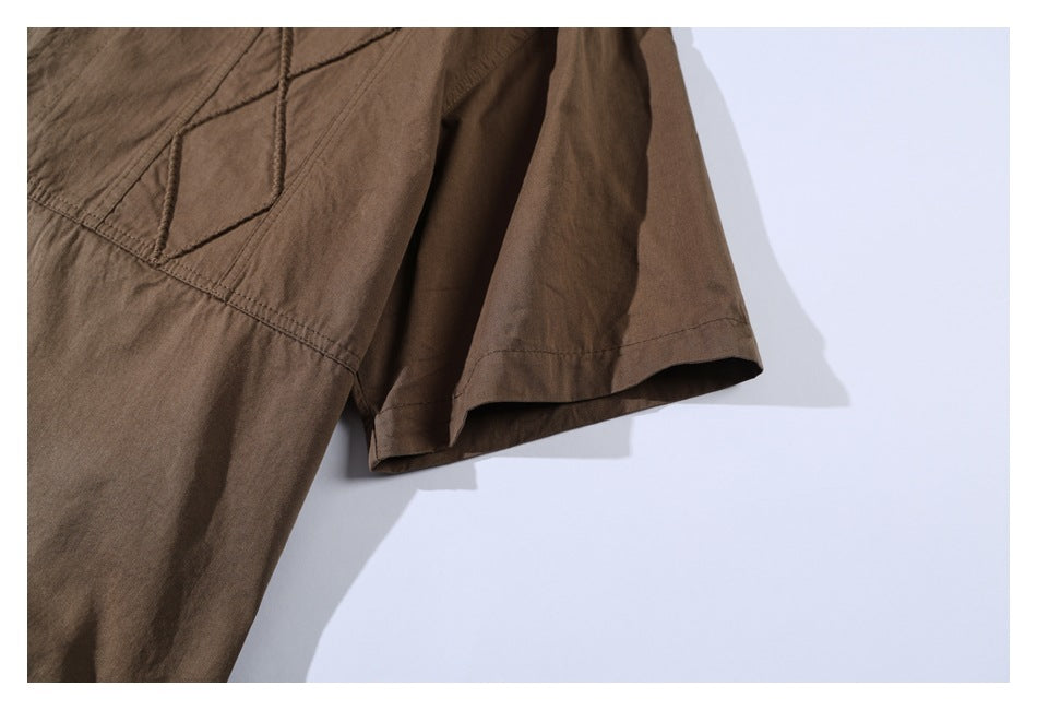 Close-up of a brown shirt's short sleeve and stitched panel seams.