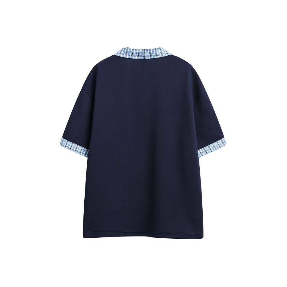 Back view of a loose navy short-sleeve shirt with a blue plaid collar and cuffs.