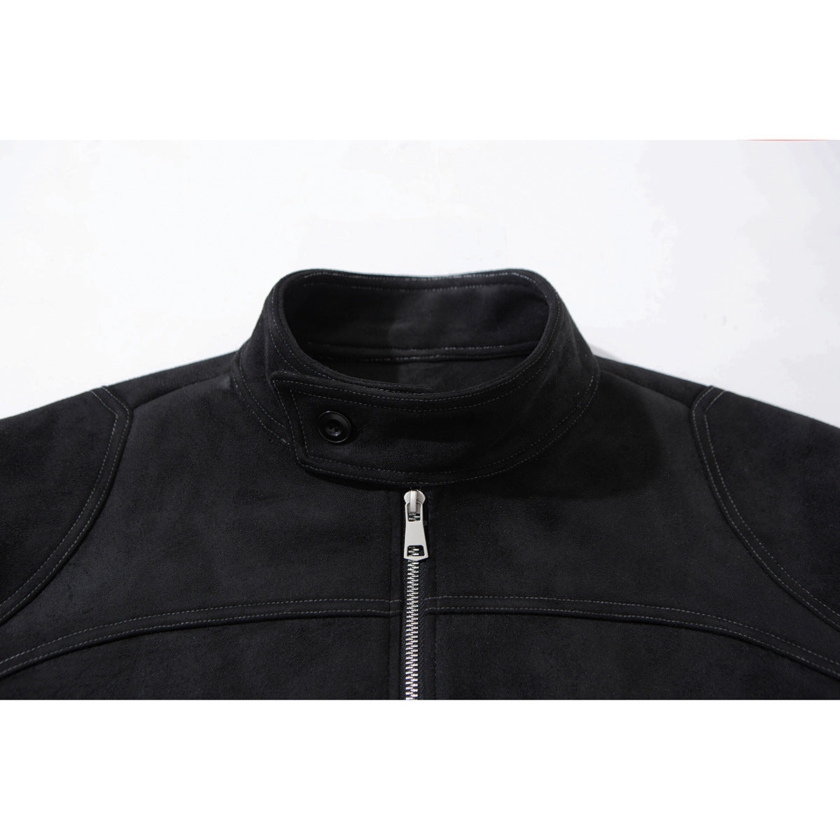Close-up of a black jacket's stand collar, button, center zipper and curved stitching.