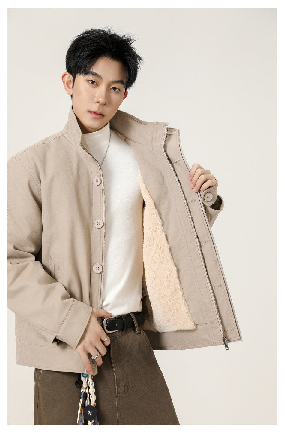 Model displays the beige jacket open, showing its zipper closure and light-colored fuzzy lining.