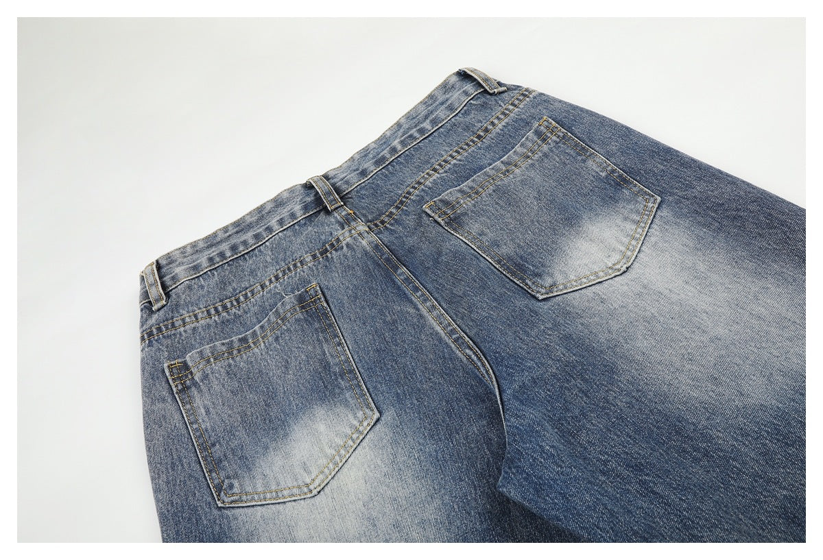 Flat-lay rear view of faded blue jeans with two back pockets and contrast stitching.
