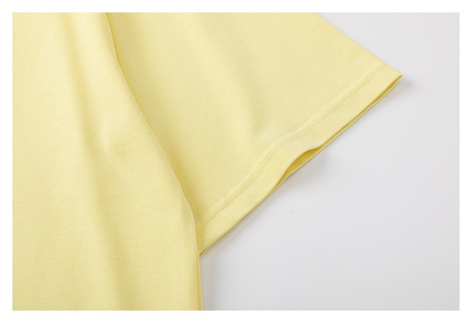 Close-up of a pale yellow T-shirt short sleeve and its stitched hem.
