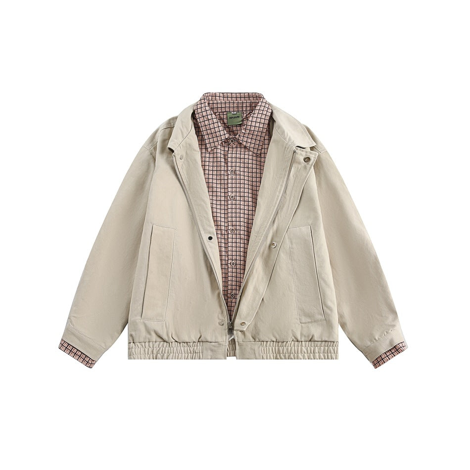 Front view of a light beige jacket with a zip front, snap lapels, patch pockets, and pink checked collar and cuffs.