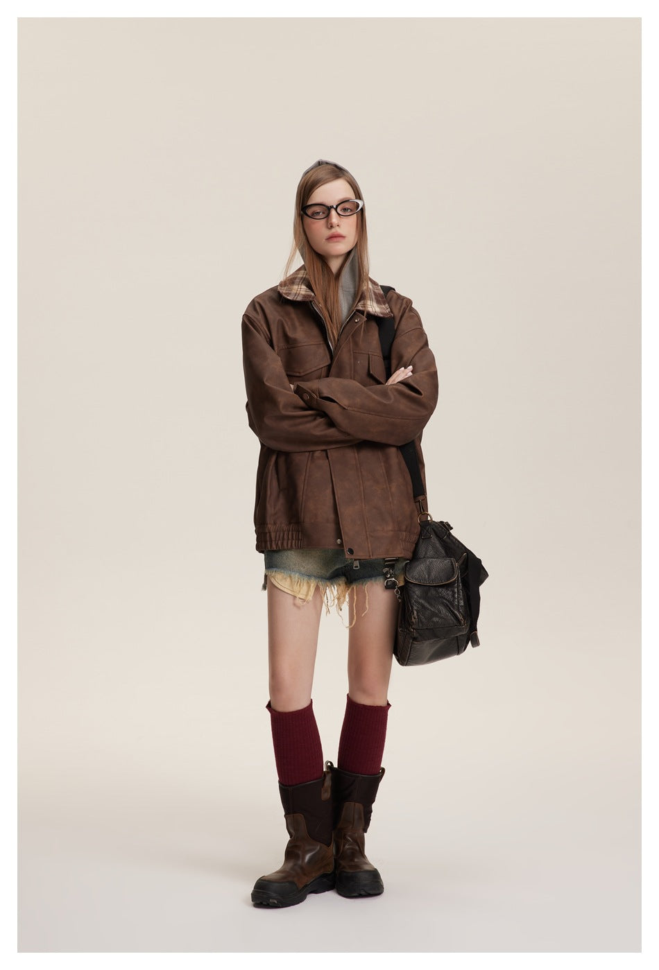 Full-length front view of a model wearing the brown plaid-collar jacket with shorts and boots.