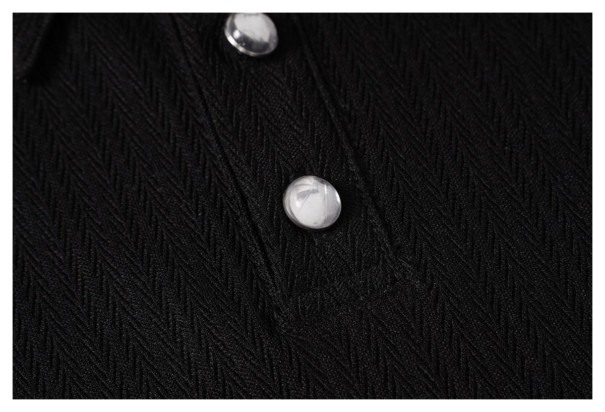 Close-up showing the black shirt's raised diagonal texture and a shiny round button.