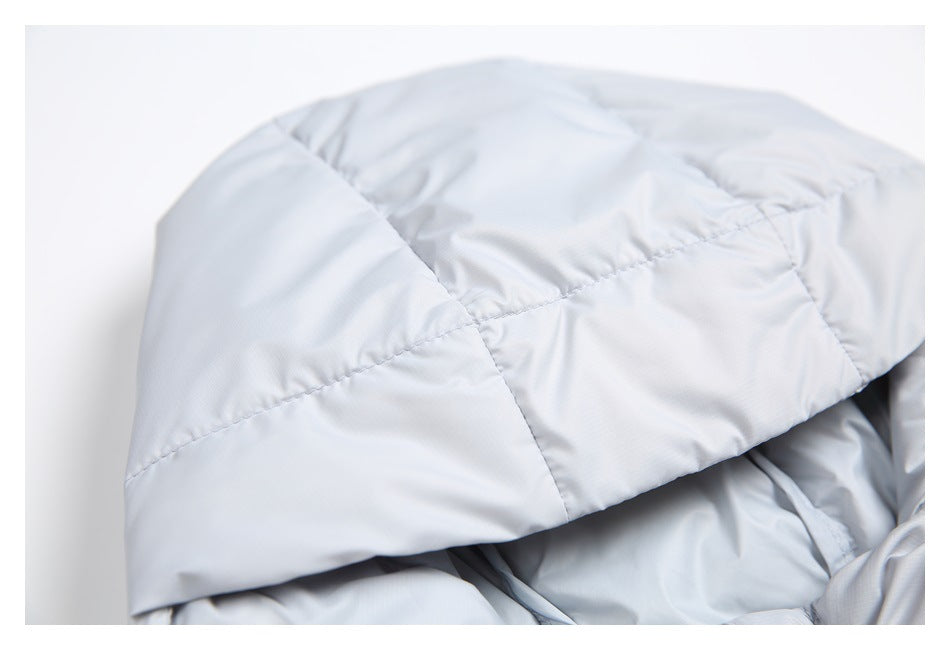 Close-up of a light gray quilted jacket hood with curved stitched panels.
