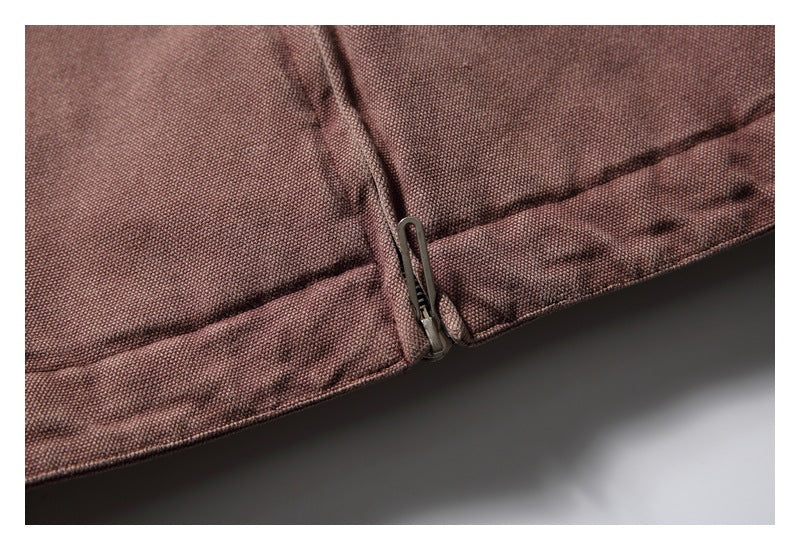 Close-up of the jacket's lower front hem and metal zipper pull.