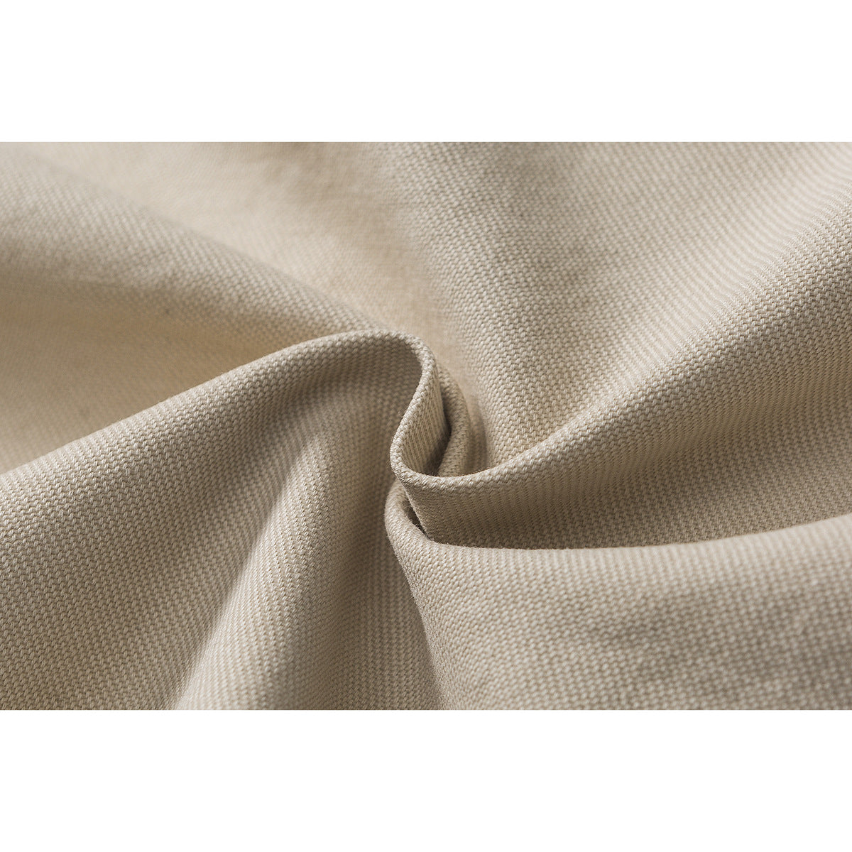 Macro view of beige woven fabric draped to show its textured surface.
