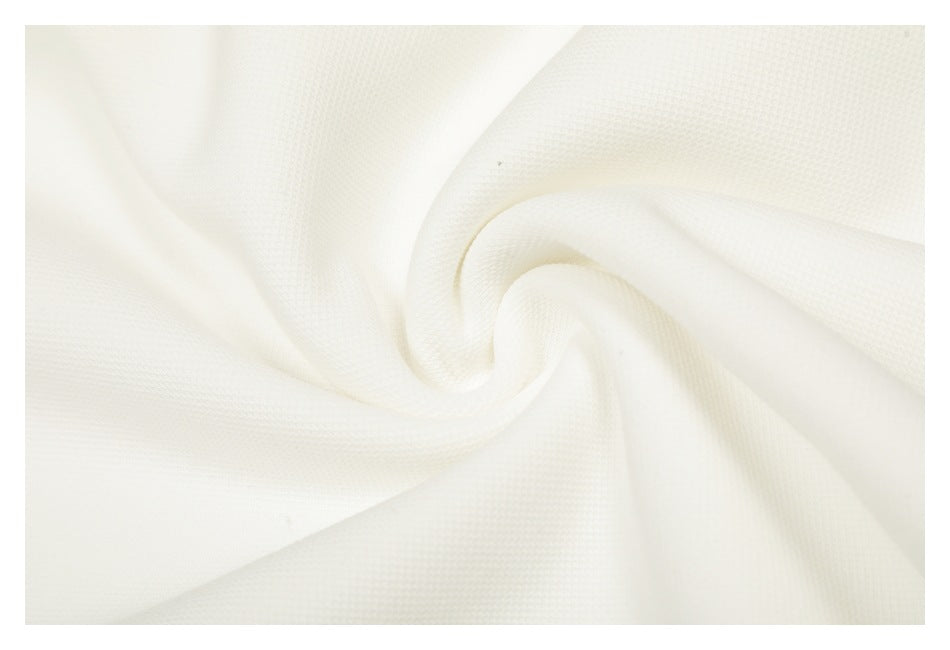 Close-up of textured white fabric gathered into a soft spiral fold.