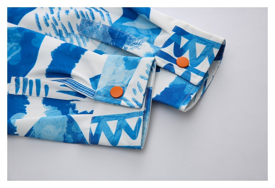 Close-up of the printed shirt's cuff and orange button.
