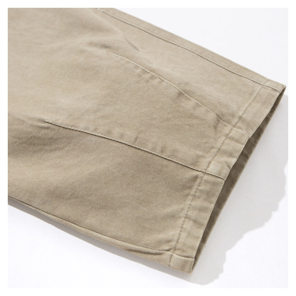 Close-up of the stitched hem and seam on a beige garment.