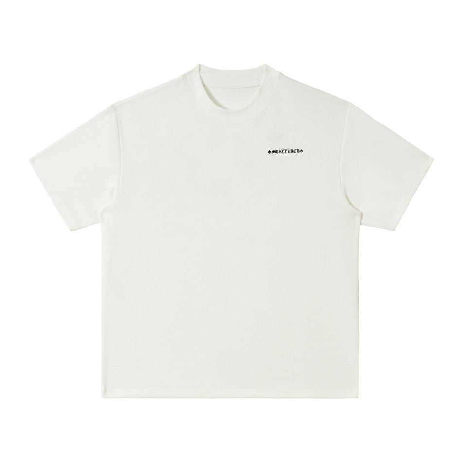 Front view of a white short-sleeve crew-neck T-shirt with a small dark chest mark.