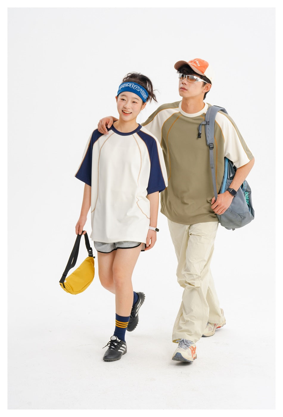Two models walk in ivory-and-navy and olive-and-ivory raglan shirts.