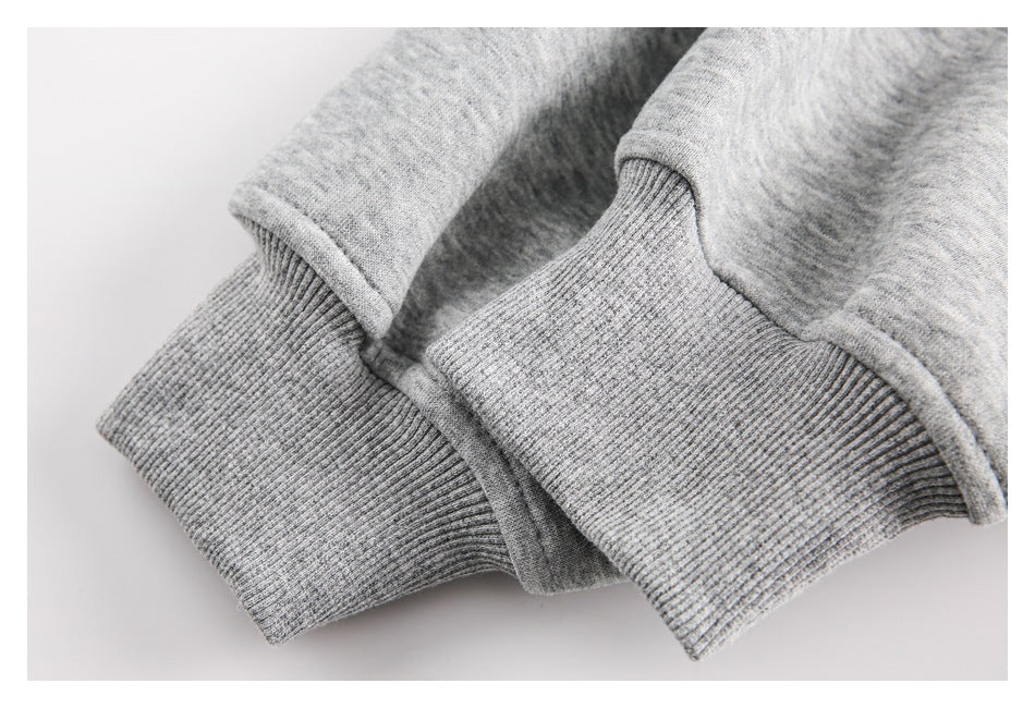 Close-up of light gray ribbed cuffs and adjoining garment fabric.