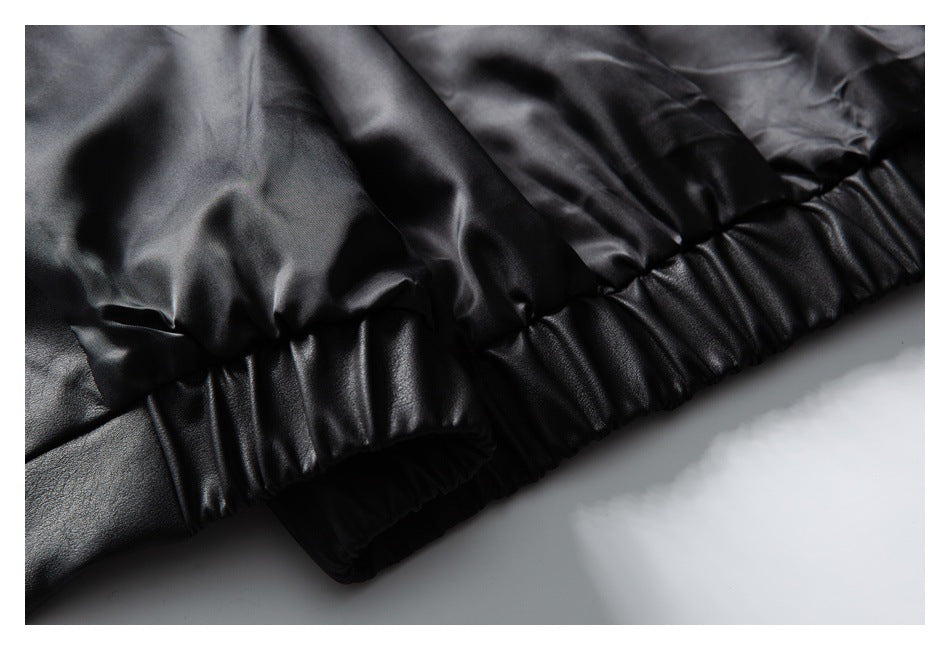 Close-up of the black jacket's gathered elastic hem from the inside.