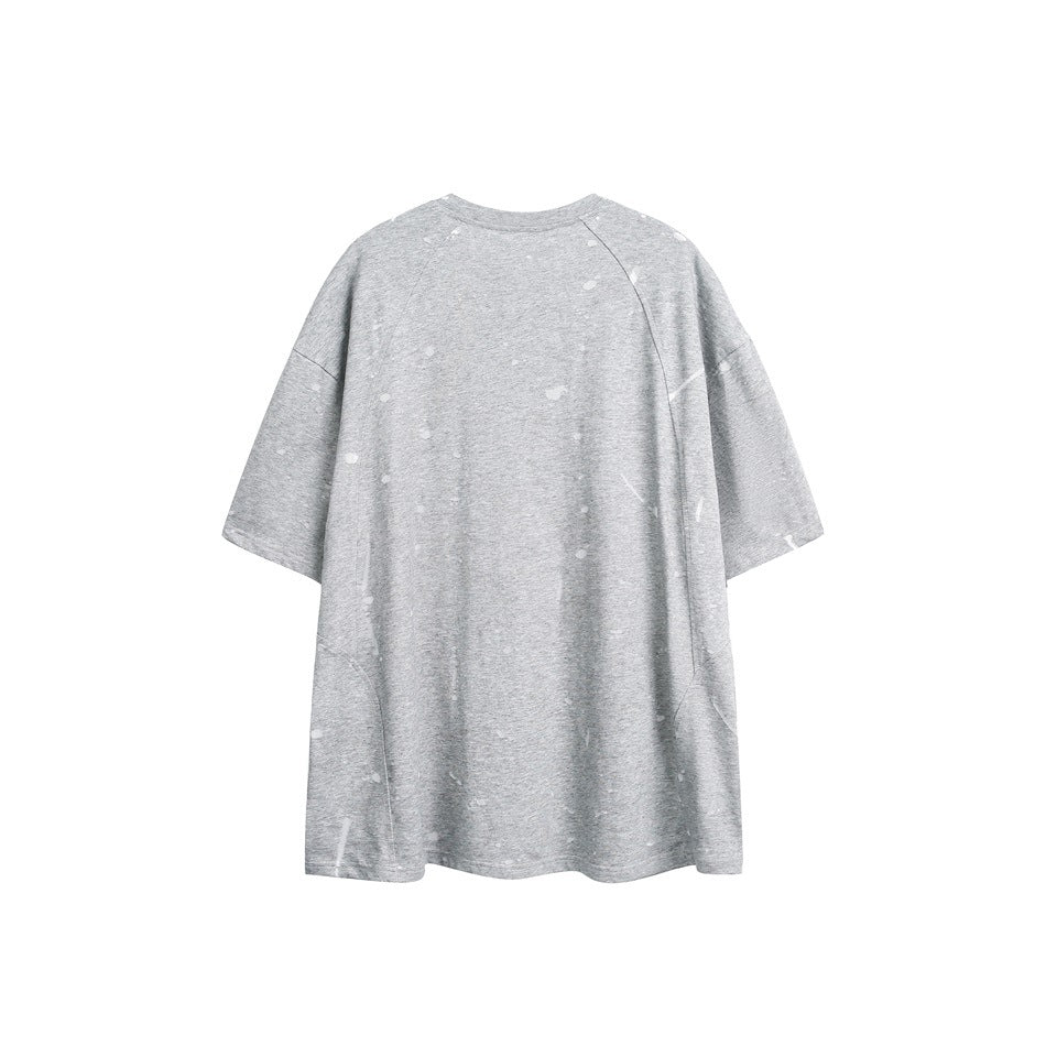 Back view of a loose gray short-sleeve crewneck T-shirt with scattered light distress marks.
