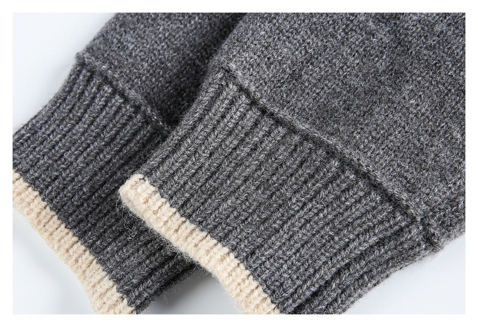 Close-up of a gray ribbed knit cuff or edge with cream trim.
