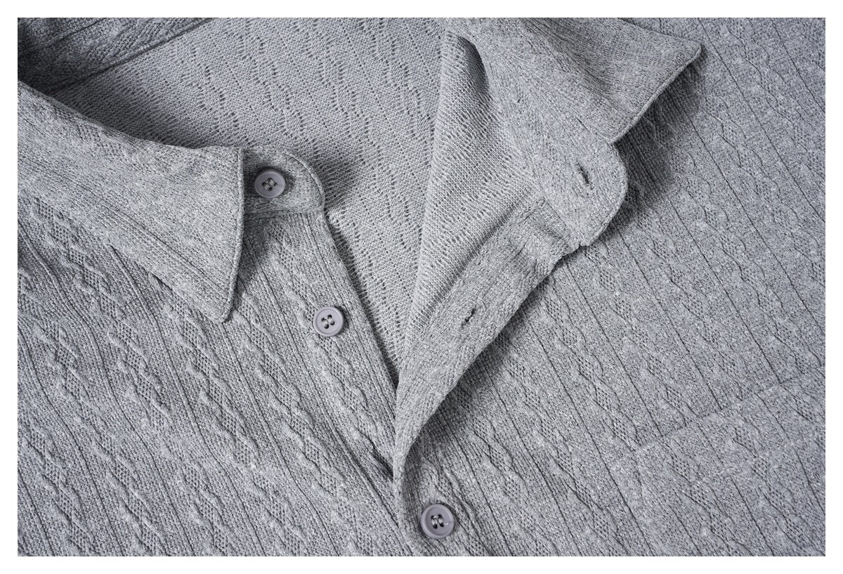 Close-up of the gray knit shirt's open collar and button placket.