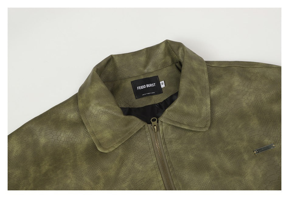 Close-up of the olive jacket’s collar, front zipper, and inner neck label.
