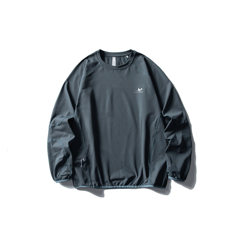 Dark slate teal long-sleeve crew-neck top flat lay with blue contrast topstitching and gathered hem