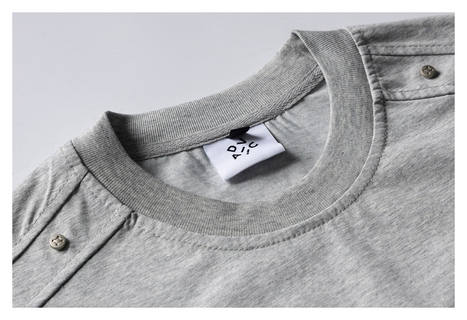 Close-up of a heather gray T-shirt’s ribbed crew neck, shoulder stitching, and sewn-in neck label.