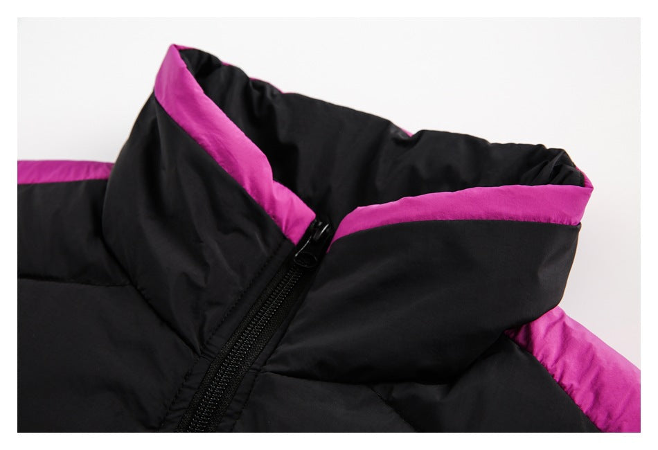 Black padded jacket collar detail with magenta lining and a black zipper.