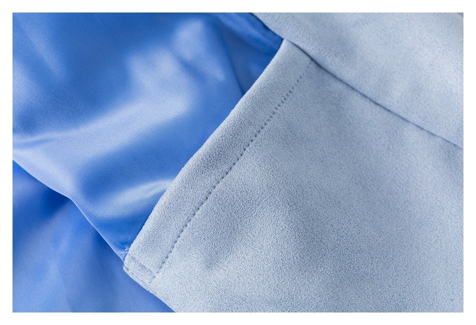 Close-up of the light blue jacket's stitched edge and smooth blue lining.