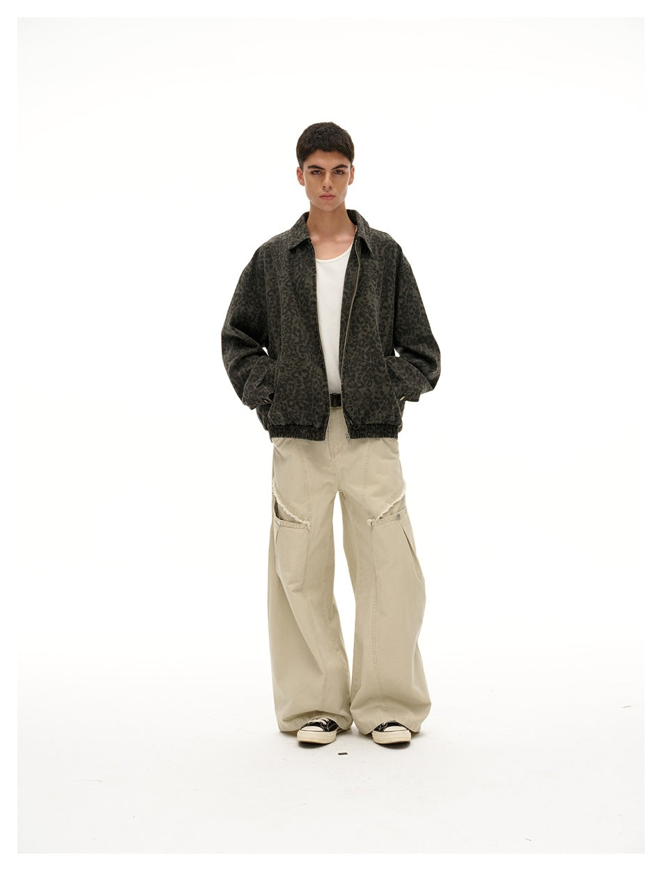 Full-length front view of a model in a dark olive leopard-print jacket and wide beige trousers.