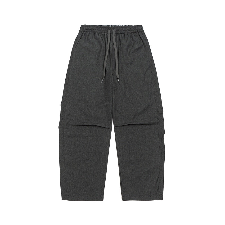 Flat-lay front of dark charcoal gray wide-leg drawstring pants with elastic waist and side pockets