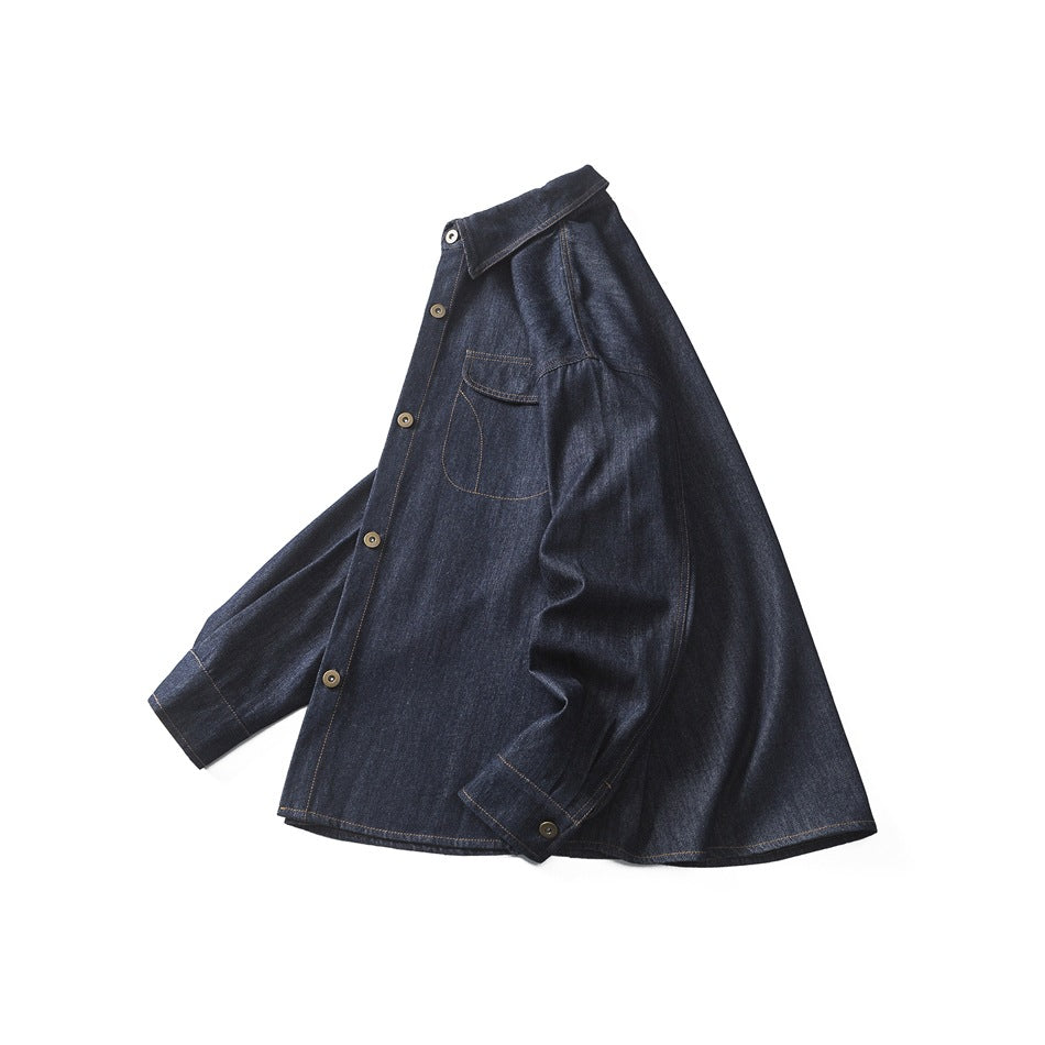 Angled front view of a dark indigo denim button-up shirt laid flat, with a pointed collar and chest pocket.
