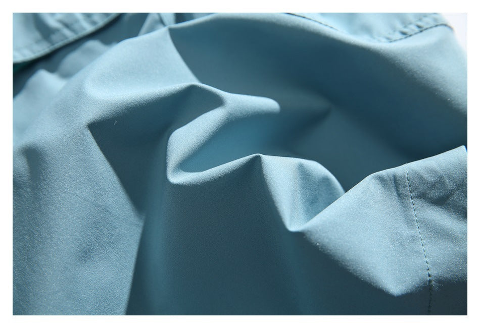 Close-up of the smooth light blue shorts fabric and a stitched seam.