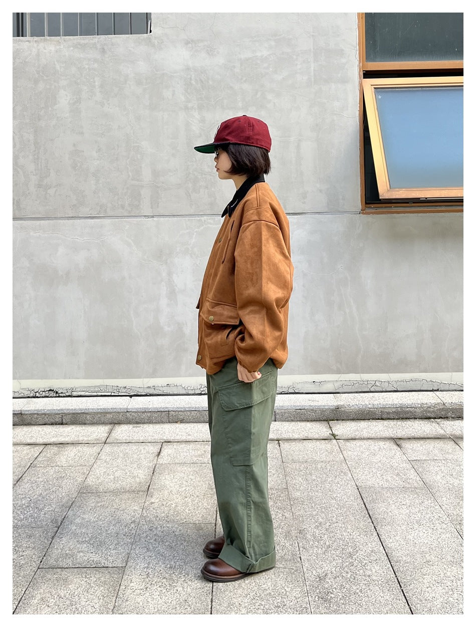 Side view of a person wearing a khaki-brown jacket with black collar, green cargo pants and a maroon cap