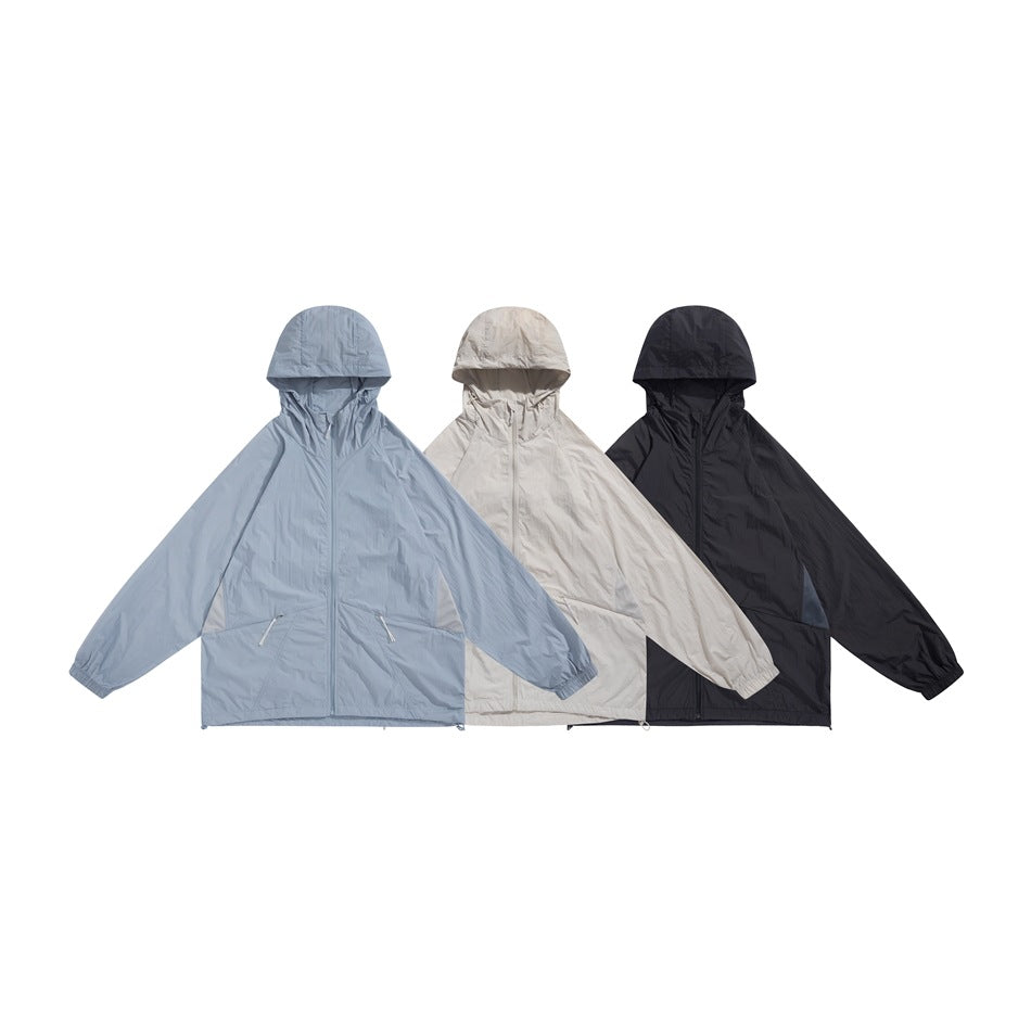 Three hooded zip jackets shown together in pale blue, light beige, and black.