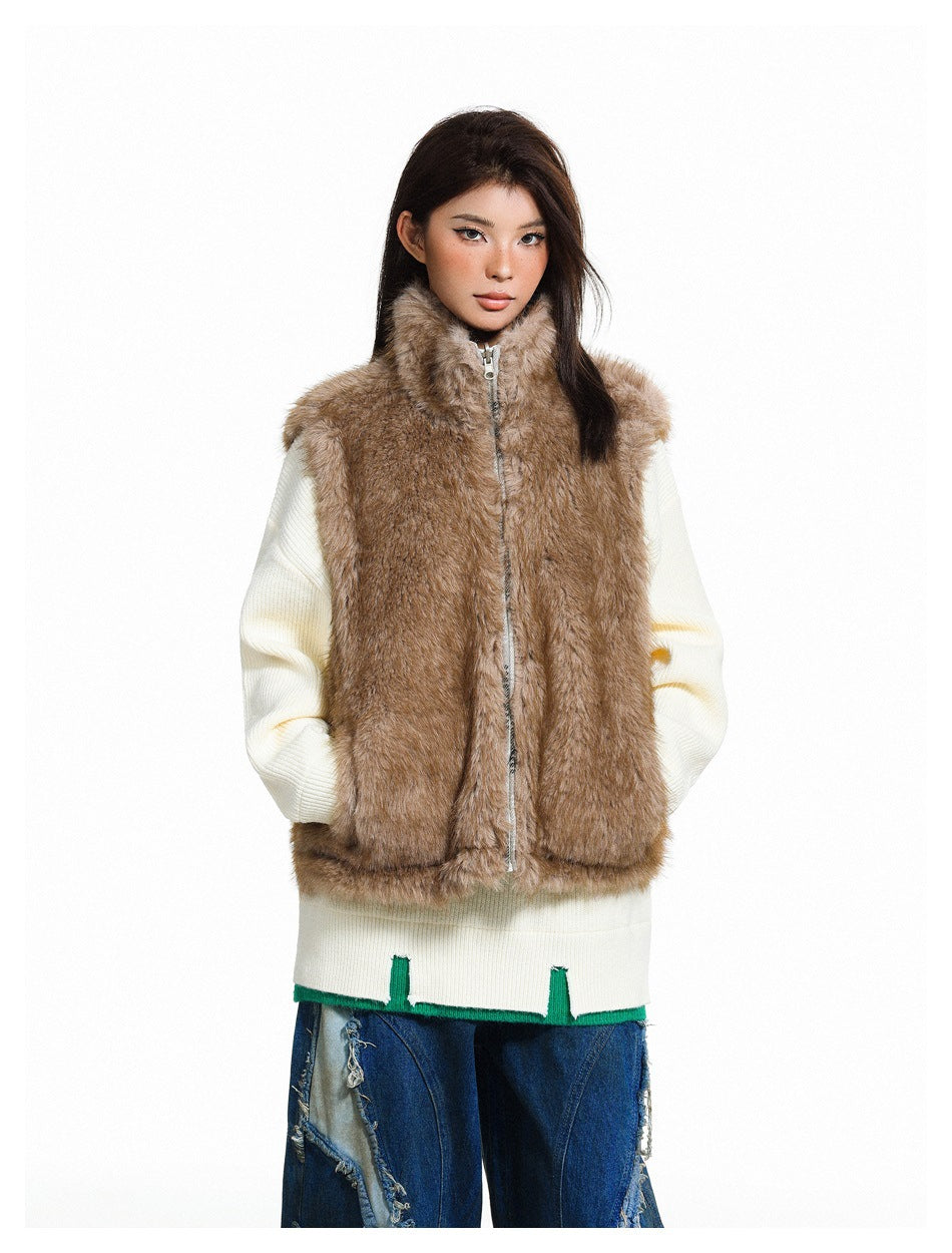 Close front view of a model wearing a zipped brown shaggy vest over an ivory sweater.