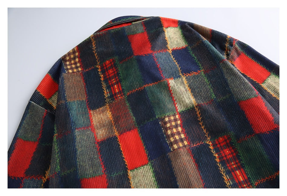 Upper back of a flat-laid collared garment in a multicolor patchwork pattern of red, navy, green, and brown.