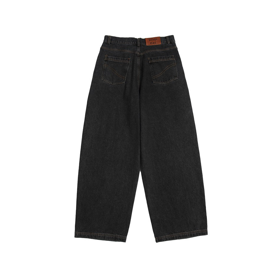 Back view of black wide-leg jeans with two rear pockets and a small waistband patch.