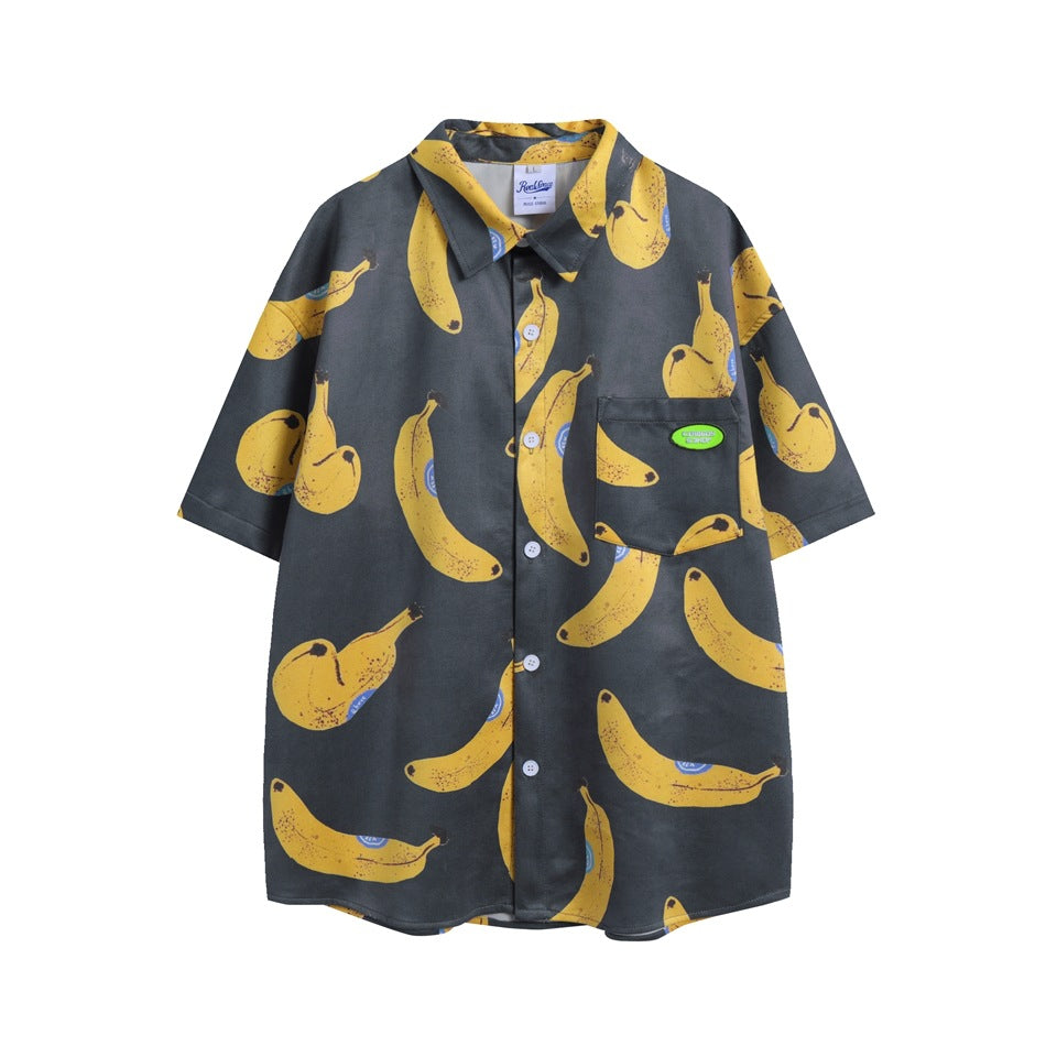 Charcoal-gray short-sleeve button-up shirt with an all-over yellow banana print and chest pocket, flat front view