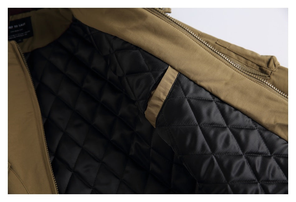 The open khaki jacket reveals a black diamond-quilted lining and a small inner pocket.