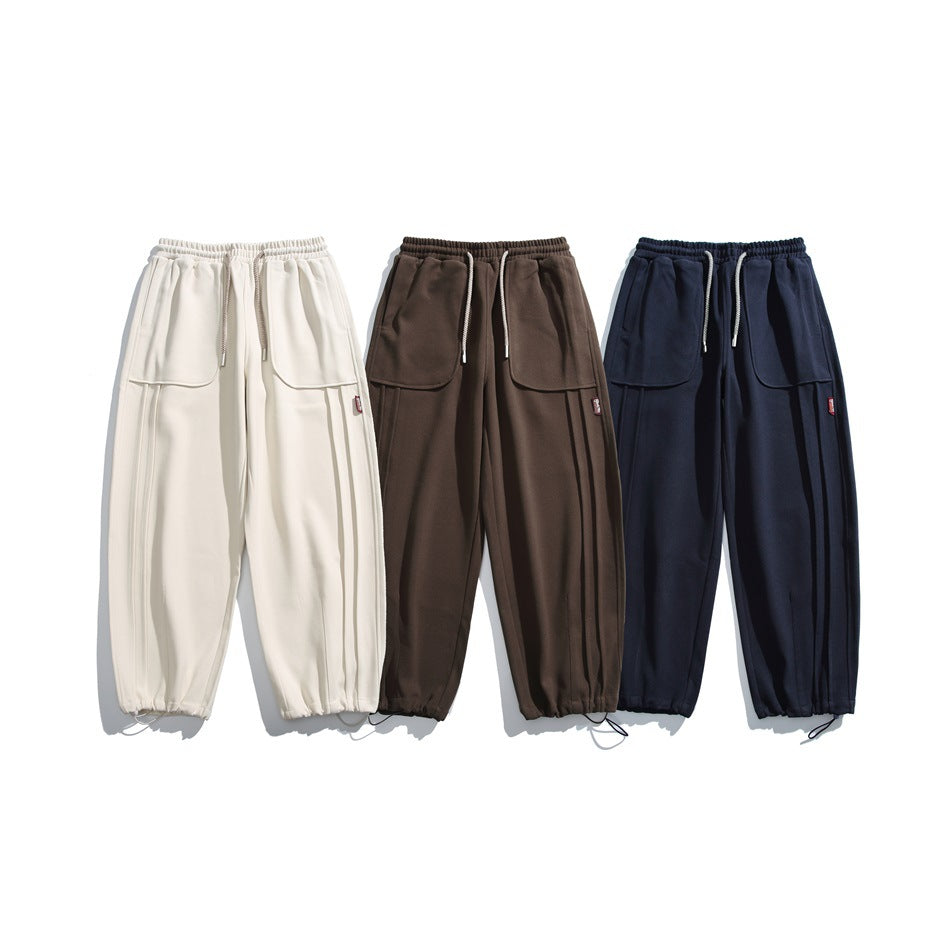 Three pairs of loose drawstring pants shown flat, in cream, brown, and dark navy.