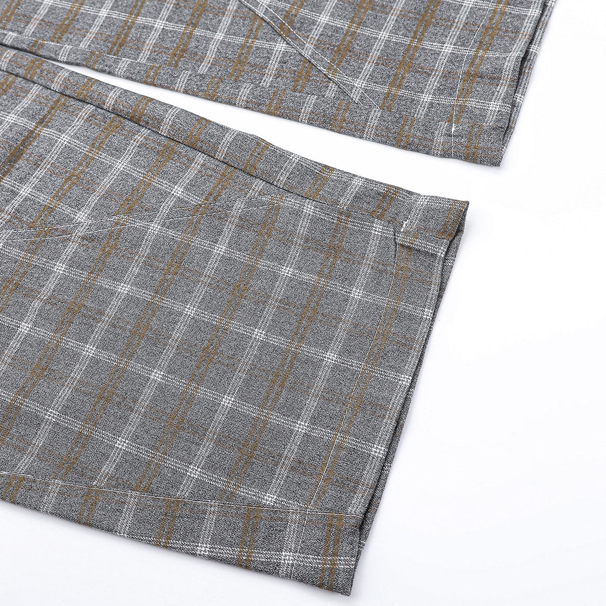Close-up of the wide hems on gray plaid trousers.