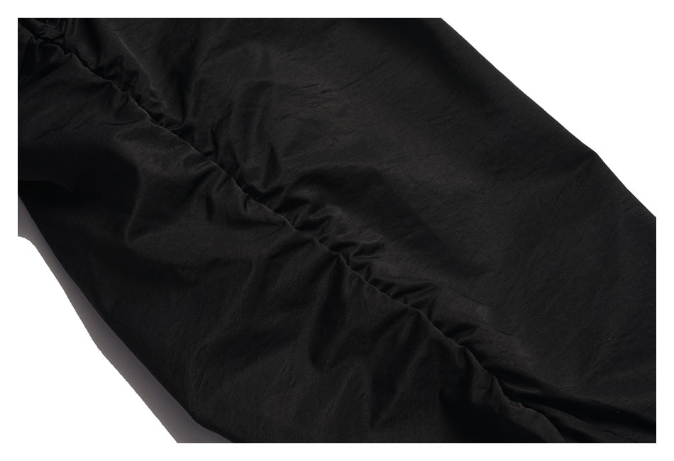 Close-up of black garment fabric with a diagonal stitched seam.