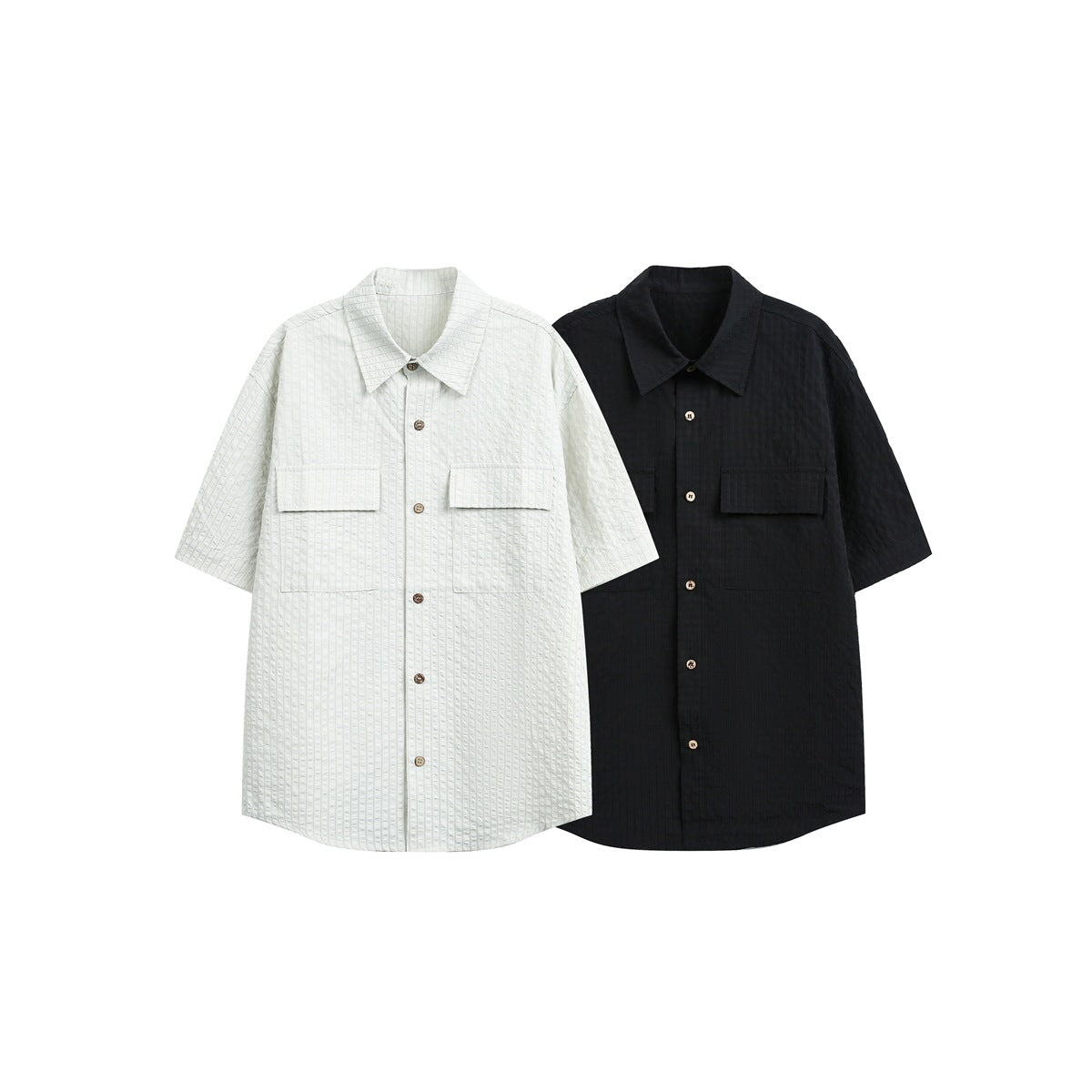 Front view of white and black short-sleeve button-up shirts with pointed collars and flap chest pockets.